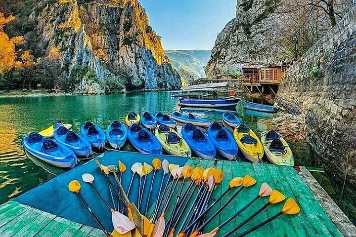 A colorful array of kayaks and paddles ready for use at Matka Canyon.